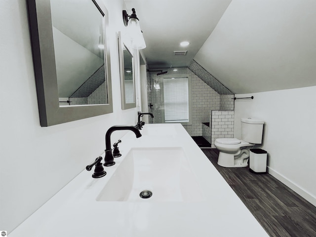 bathroom featuring an enclosed shower, vanity, vaulted ceiling, wood-type flooring, and toilet