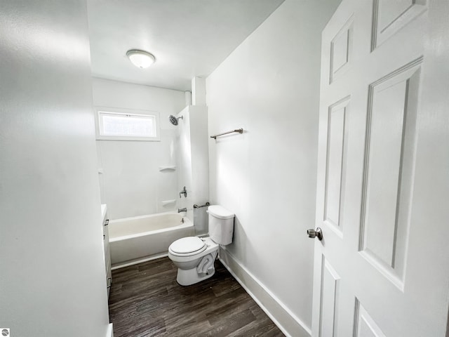 bathroom featuring toilet, shower / bathing tub combination, and hardwood / wood-style flooring