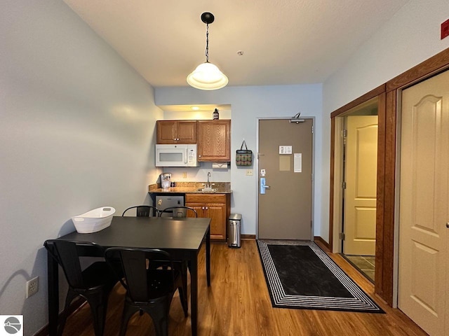 dining space featuring light hardwood / wood-style floors and sink