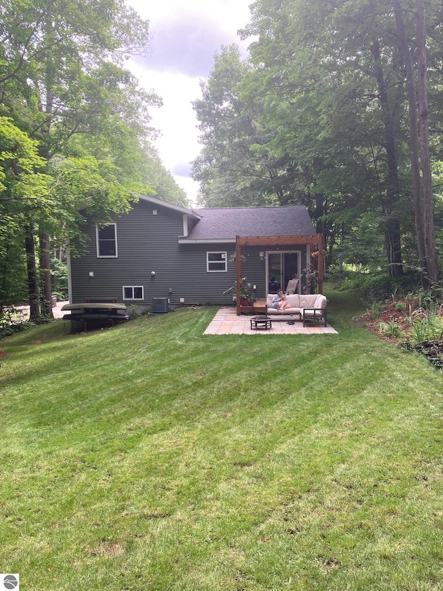 back of property with a lawn, central AC, outdoor lounge area, and a patio