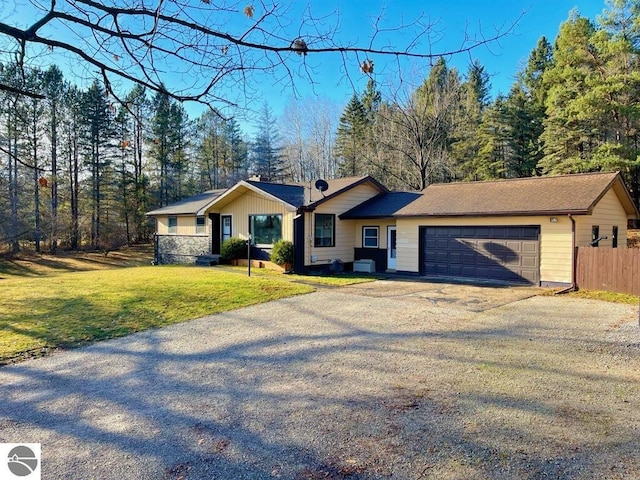 ranch-style house featuring a front lawn and a garage