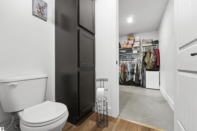 bathroom with hardwood / wood-style floors and toilet