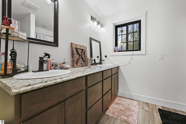 bathroom with wood-type flooring and vanity