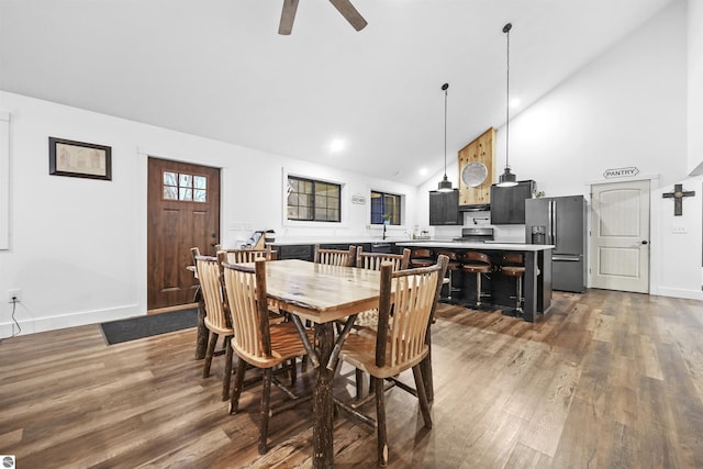 dining room featuring hardwood / wood-style floors, high vaulted ceiling, and ceiling fan