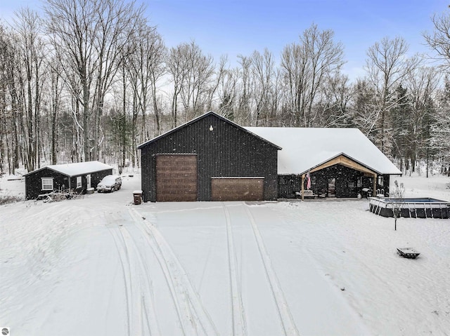 exterior space featuring an outbuilding and a garage