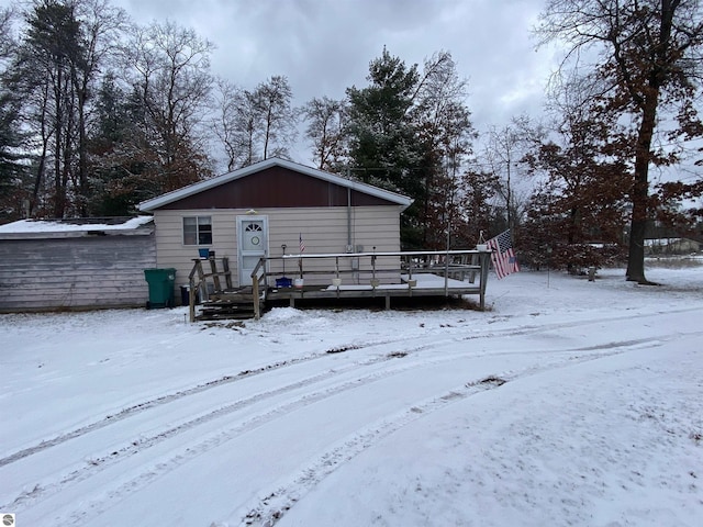 snow covered property featuring a wooden deck