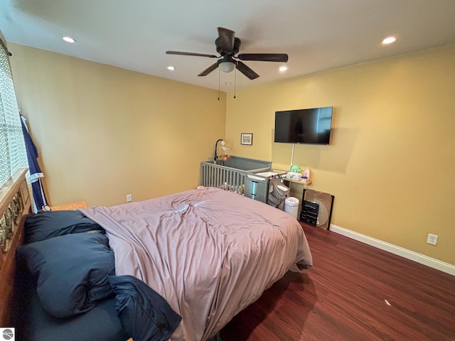 bedroom featuring dark hardwood / wood-style flooring and ceiling fan