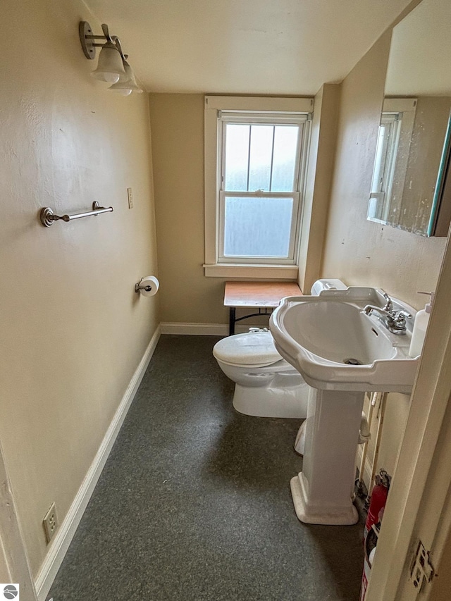 bathroom featuring toilet and sink