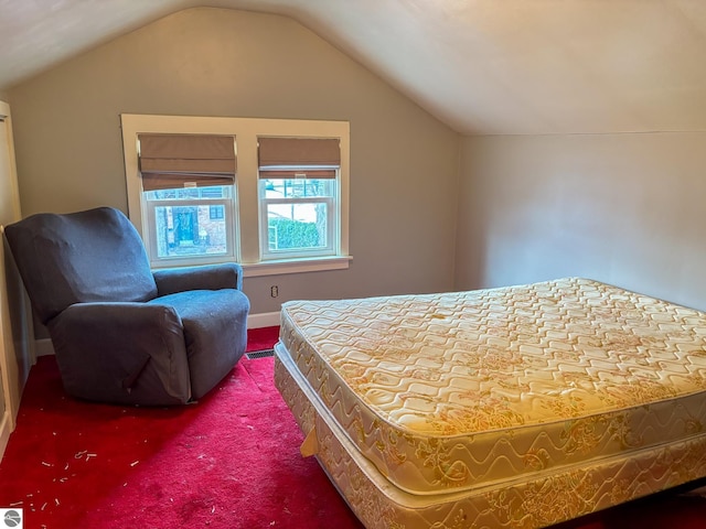 carpeted bedroom with vaulted ceiling