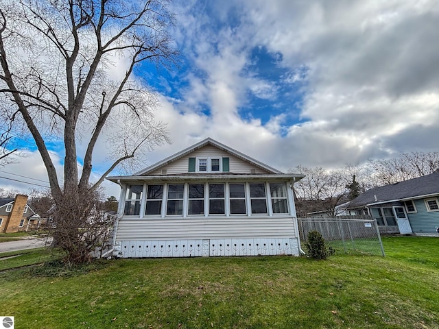 exterior space with a sunroom and a yard