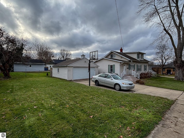 exterior space with an outbuilding, a garage, and a front yard