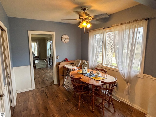 dining space featuring ceiling fan and dark hardwood / wood-style flooring