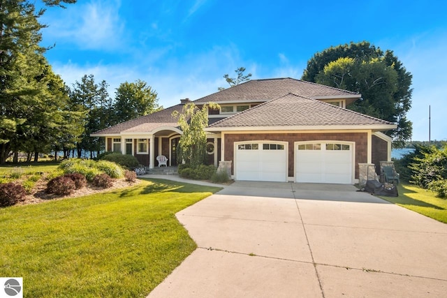 view of front of property featuring a garage and a front lawn