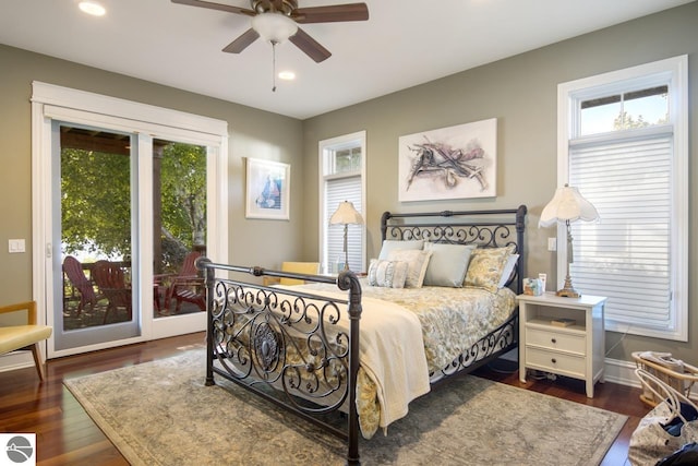 bedroom featuring ceiling fan, dark hardwood / wood-style floors, and access to outside