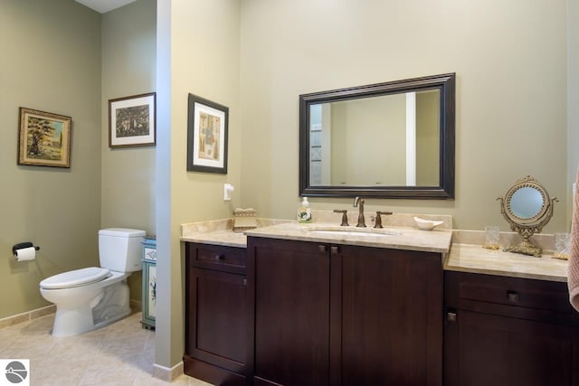 bathroom featuring tile patterned floors, vanity, and toilet