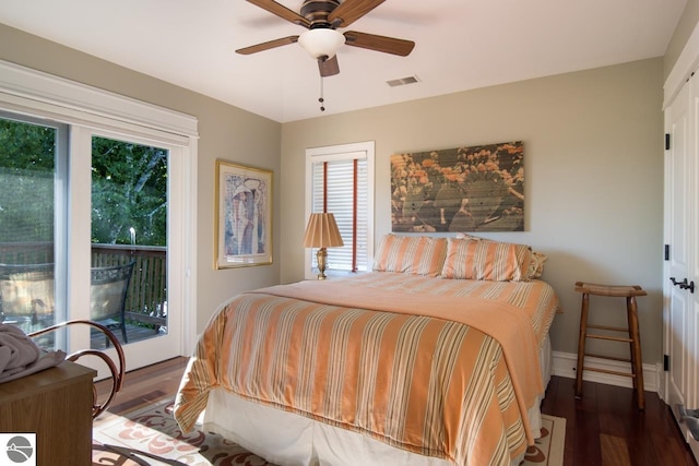 bedroom with hardwood / wood-style floors, access to outside, multiple windows, and ceiling fan