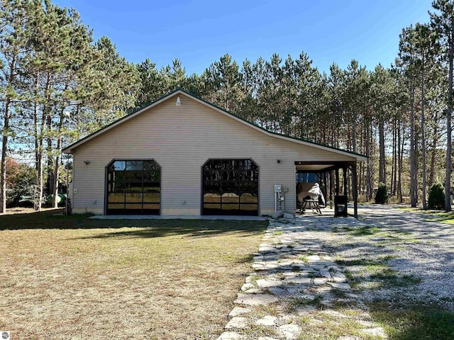 view of home's exterior with an outbuilding, a yard, and a garage