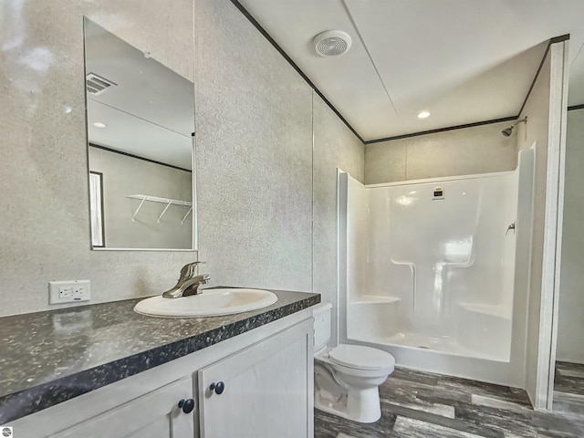 bathroom featuring wood-type flooring, toilet, and vanity