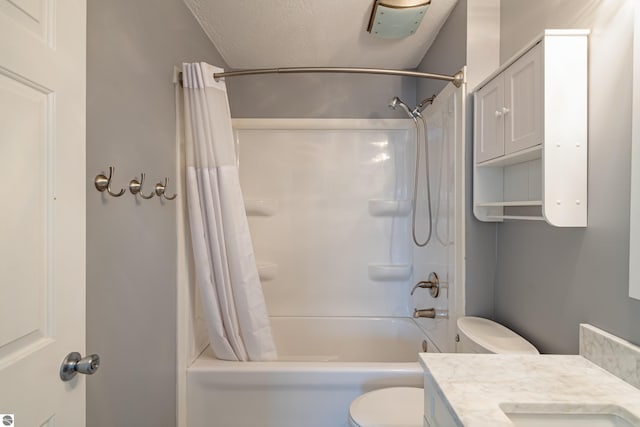 full bathroom featuring vanity, shower / bath combo, toilet, and a textured ceiling