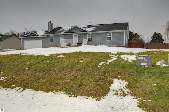 single story home with a garage and a front lawn