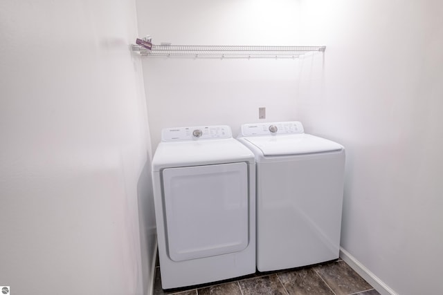 laundry area featuring washing machine and clothes dryer and dark hardwood / wood-style floors