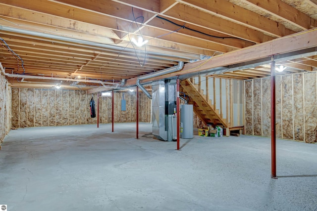 basement featuring heating unit and water heater