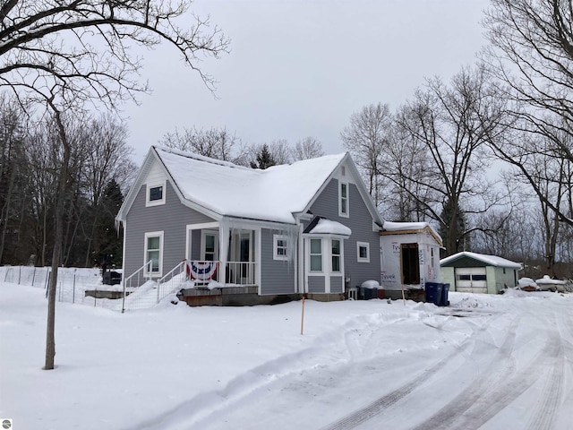 view of front facade featuring a detached garage and an outdoor structure