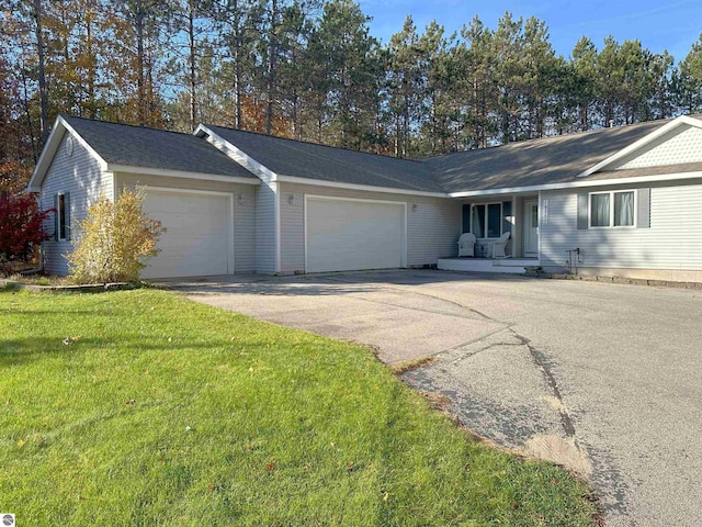 ranch-style home with a garage and a front lawn