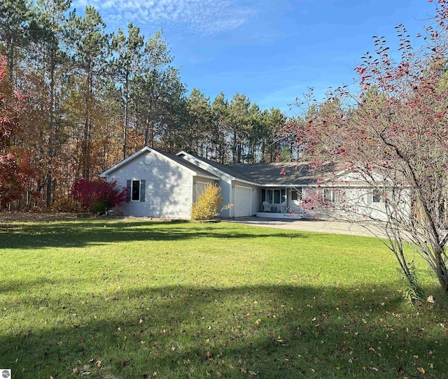 exterior space with a yard and a garage