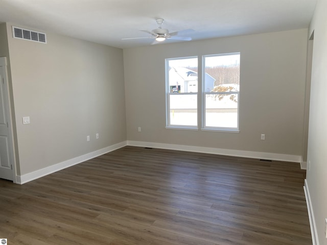 unfurnished room featuring ceiling fan and dark hardwood / wood-style floors