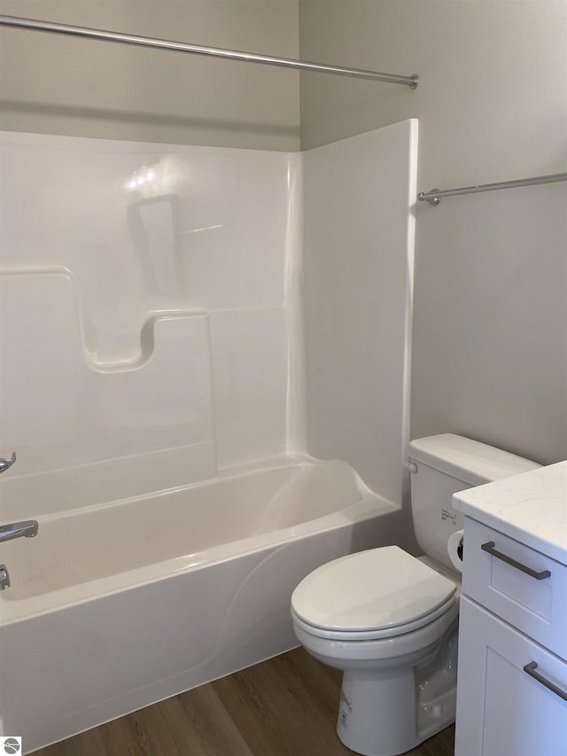 full bathroom featuring hardwood / wood-style floors, vanity, toilet, and shower / bathing tub combination