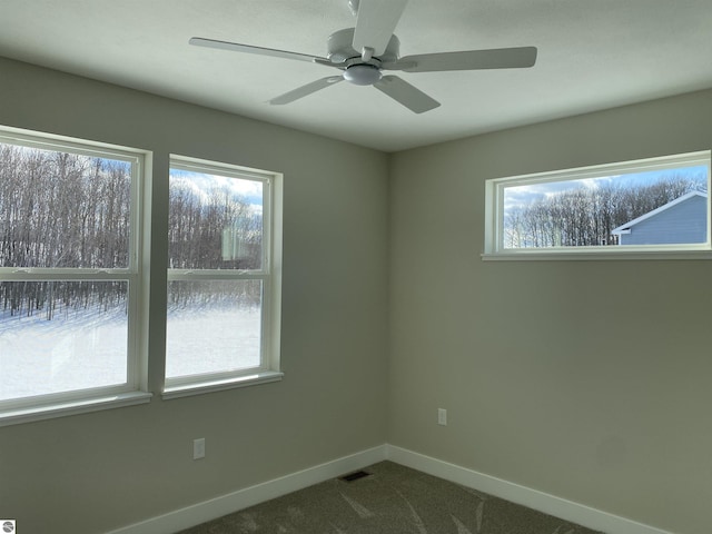 spare room featuring ceiling fan, a healthy amount of sunlight, and carpet floors