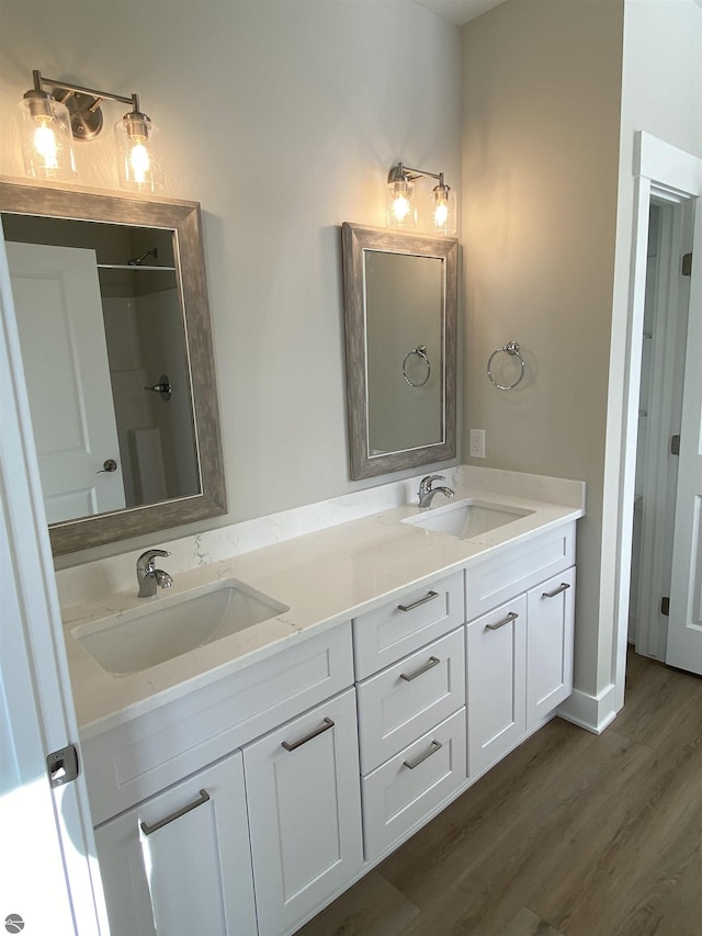 bathroom with hardwood / wood-style floors and vanity