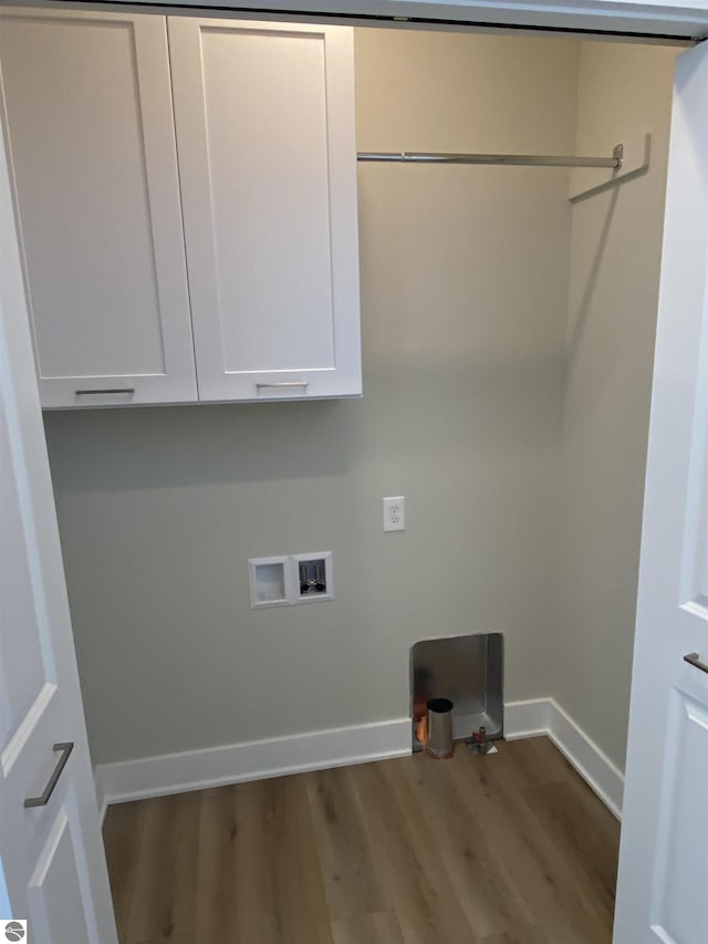 laundry area with electric dryer hookup, cabinets, wood-type flooring, and hookup for a washing machine