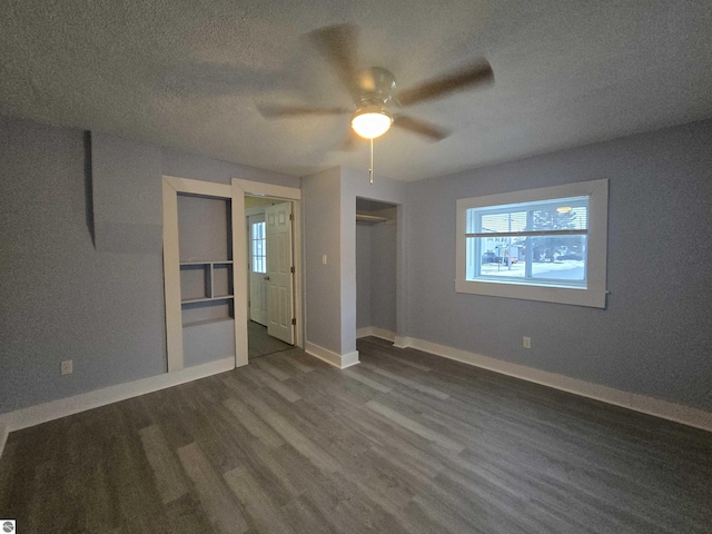 unfurnished bedroom with a textured ceiling, a closet, ceiling fan, and dark wood-type flooring