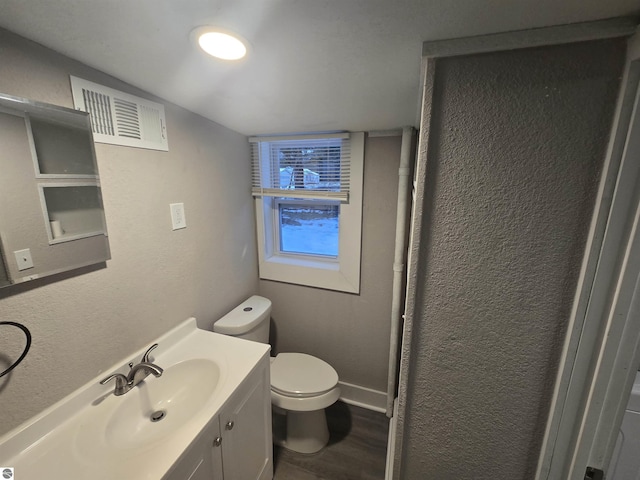 bathroom with vanity, hardwood / wood-style flooring, and toilet