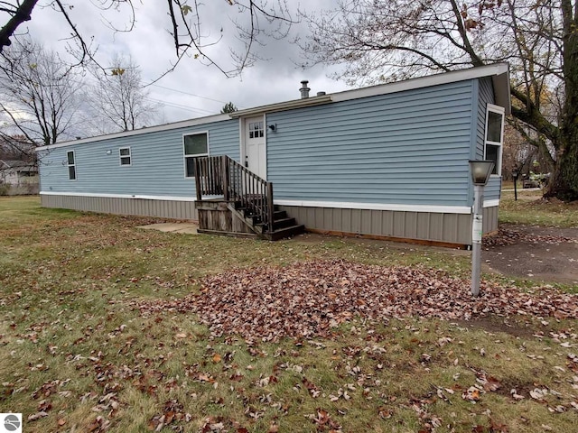 rear view of house with a yard