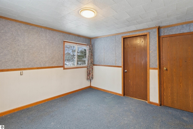 spare room with carpet and crown molding