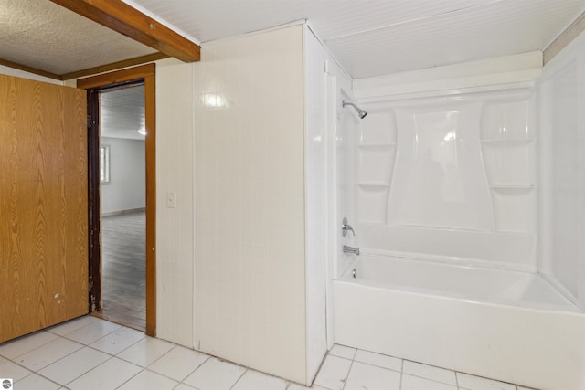 bathroom with tile patterned floors and shower / bathing tub combination