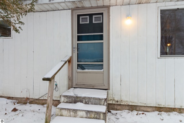 view of snow covered property entrance