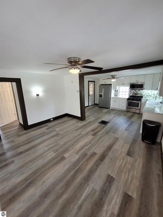 unfurnished living room with sink and dark hardwood / wood-style floors