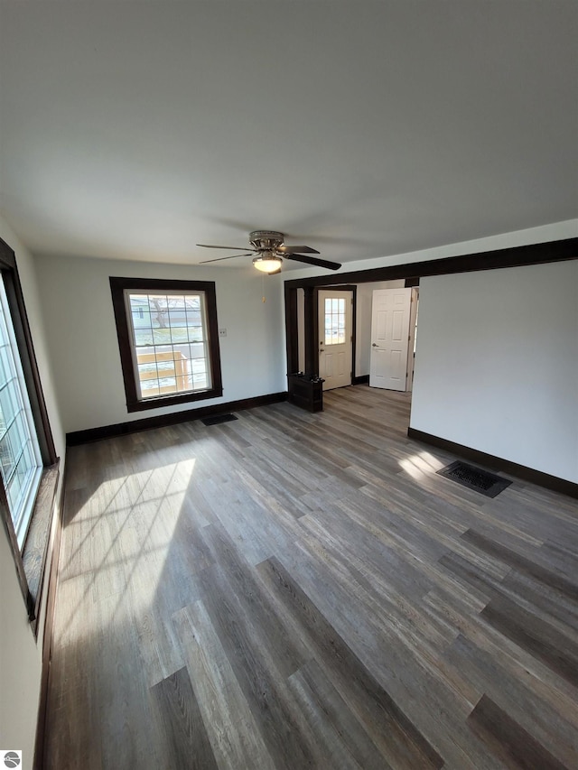 unfurnished living room with ceiling fan, hardwood / wood-style floors, and a healthy amount of sunlight