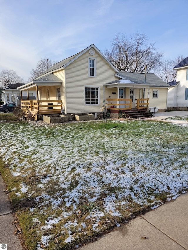 view of front of home featuring a lawn and a deck