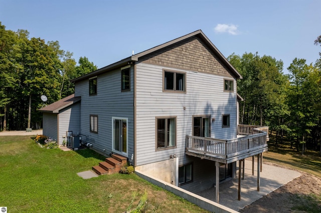 back of property featuring a patio area, a yard, central AC, and a deck