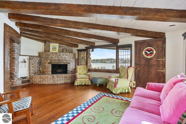 living room featuring hardwood / wood-style flooring, lofted ceiling with beams, wooden ceiling, and a fireplace