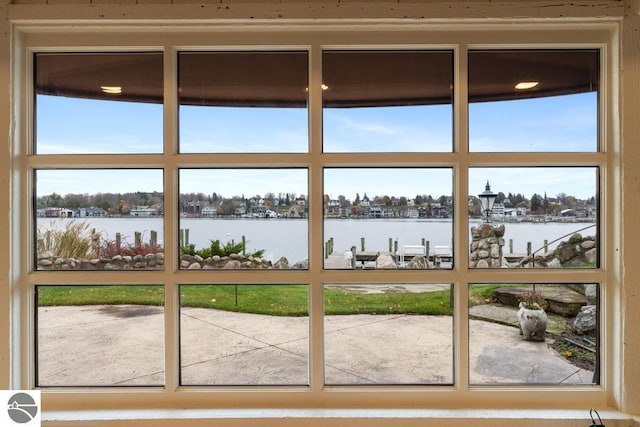 doorway to outside featuring a water view and a wealth of natural light