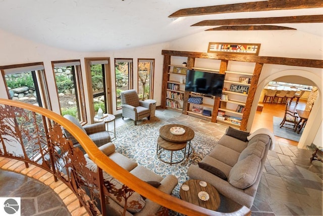 living room with lofted ceiling with beams