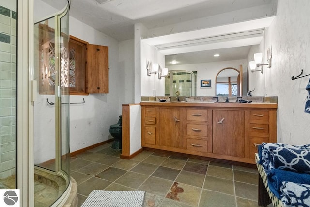 bathroom with vanity, toilet, and an enclosed shower