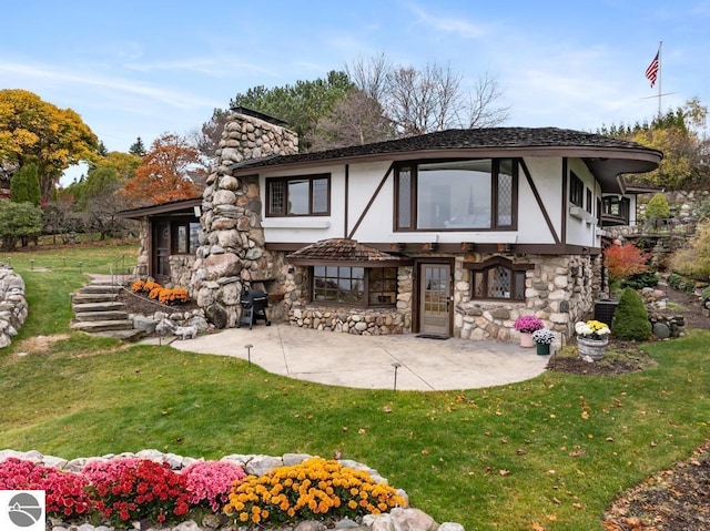 rear view of property featuring a patio area and a yard