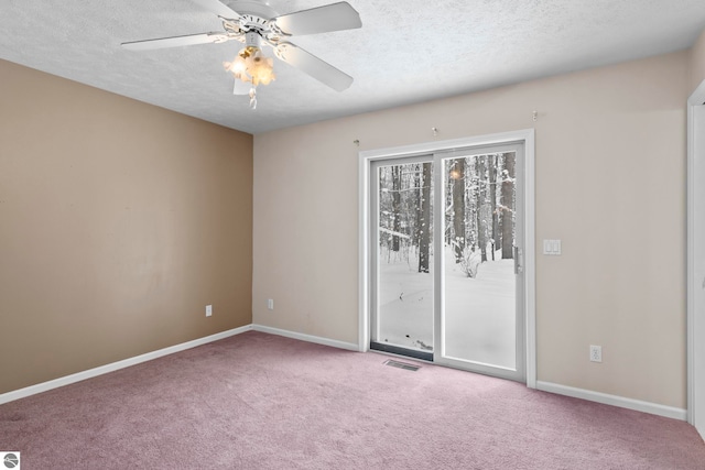 empty room with ceiling fan, carpet, and a textured ceiling